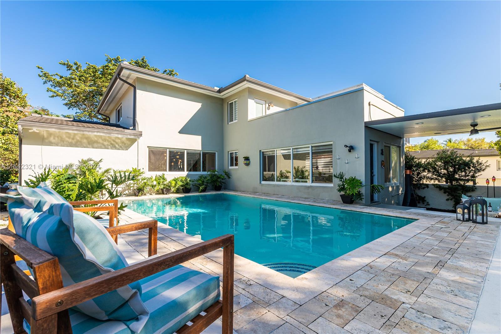 a view of house with swimming pool outdoor seating