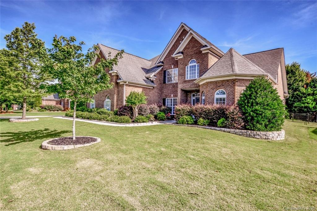 8723 Savannah Road Harrisburg, NC 28075 - Photo 2 of 44 a front view of a house with a yard