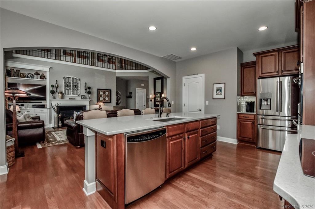 8723 Savannah Road Harrisburg, NC 28075 - Photo 12 of 44 a kitchen with stainless steel appliances granite countertop a stove and a refrigerator