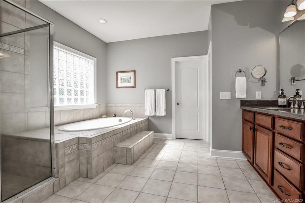 8723 Savannah Road Harrisburg, NC 28075 - Photo 21 of 44 a spacious bathroom with a tub sink and mirror