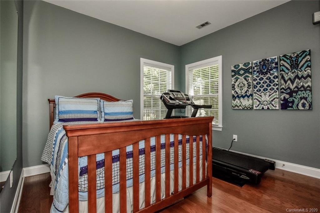 8723 Savannah Road Harrisburg, NC 28075 - Photo 24 of 44 a bedroom with a bed and wooden floor