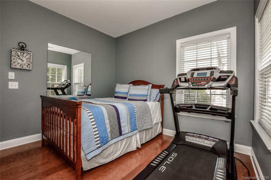 8723 Savannah Road Harrisburg, NC 28075 - Photo 25 of 44 a bedroom with a bed and wooden floor