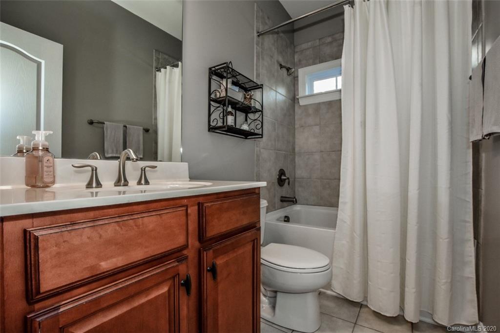 8723 Savannah Road Harrisburg, NC 28075 - Photo 26 of 44 a bathroom with a sink a toilet and shower