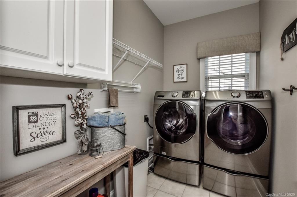 8723 Savannah Road Harrisburg, NC 28075 - Photo 27 of 44 a view of a storage and utility room with washer and dryer