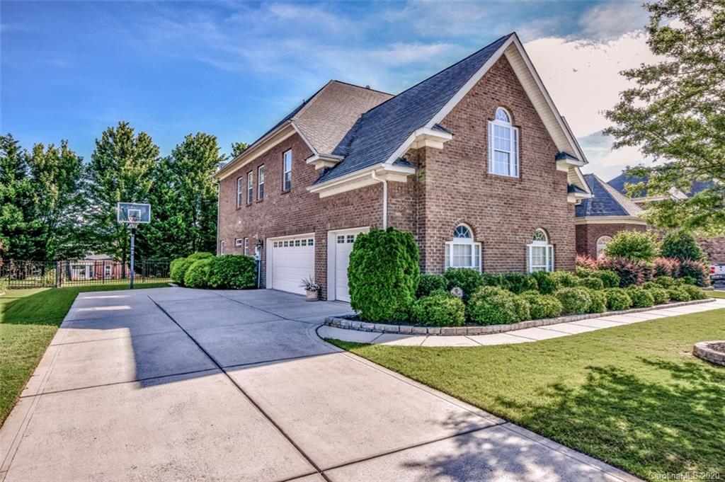 8723 Savannah Road Harrisburg, NC 28075 - Photo 4 of 44 a front view of a house with a yard