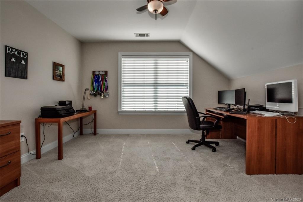 8723 Savannah Road Harrisburg, NC 28075 - Photo 31 of 44 a view of a workspace with furniture and a window