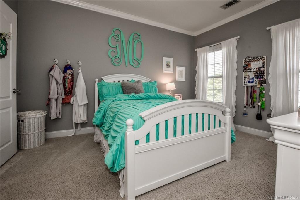 8723 Savannah Road Harrisburg, NC 28075 - Photo 32 of 44 a bedroom with furniture and a large window