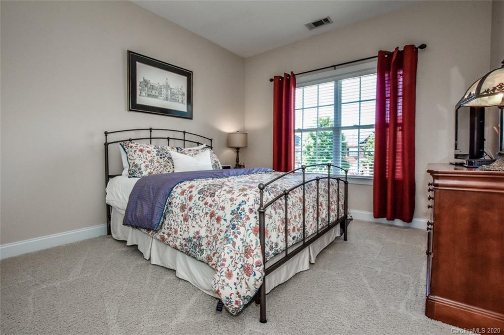 8723 Savannah Road Harrisburg, NC 28075 - Photo 35 of 44 a bedroom with a bed and a flat screen tv