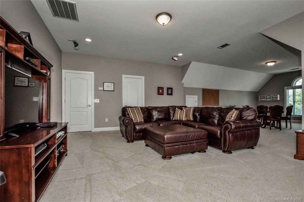 8723 Savannah Road Harrisburg, NC 28075 - Photo 37 of 44 a living room with furniture and a flat screen tv