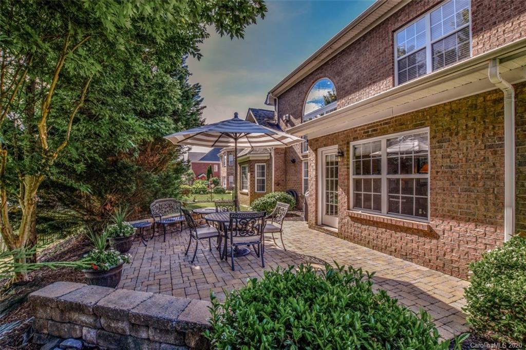 8723 Savannah Road Harrisburg, NC 28075 - Photo 41 of 44 a view of a house with backyard sitting area and garden