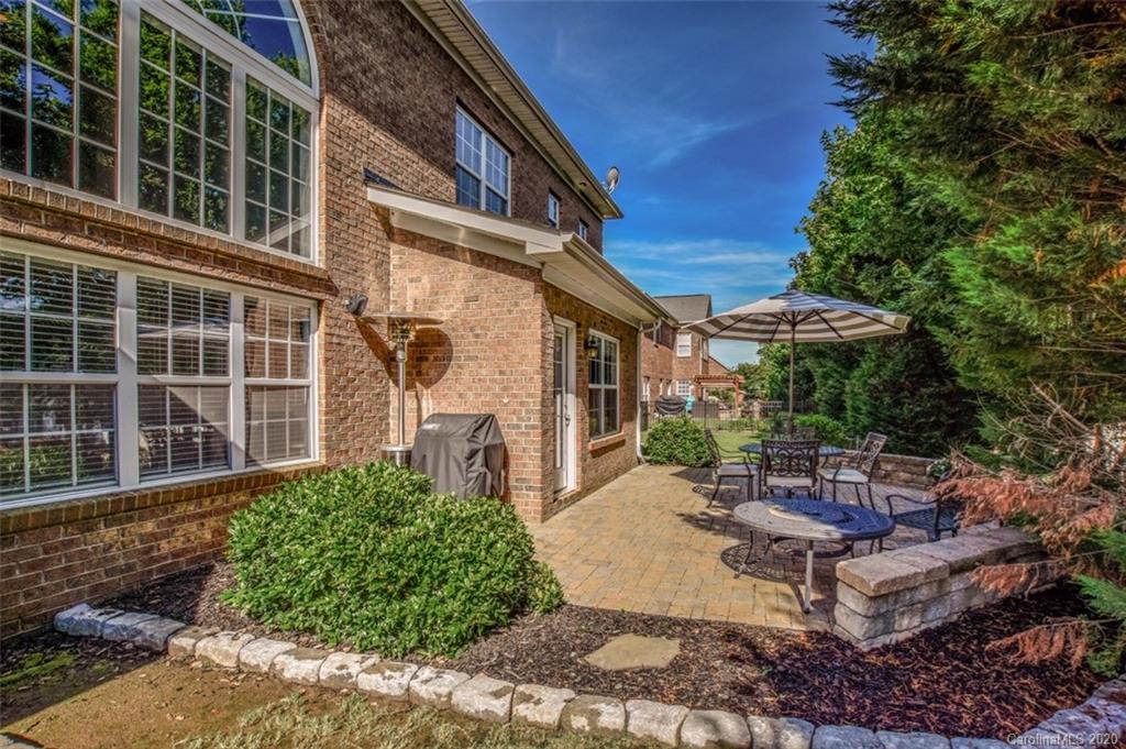 8723 Savannah Road Harrisburg, NC 28075 - Photo 42 of 44 a view of a patio with table and chairs and potted plants