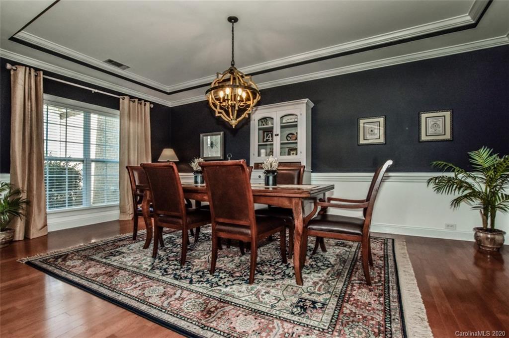 8723 Savannah Road Harrisburg, NC 28075 - Photo 7 of 44 a view of a dining room with furniture window and wooden floor