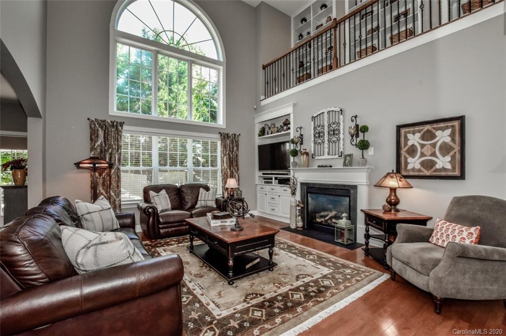 8723 Savannah Road Harrisburg, NC 28075 - Photo 9 of 44 a living room with furniture fireplace and a large window