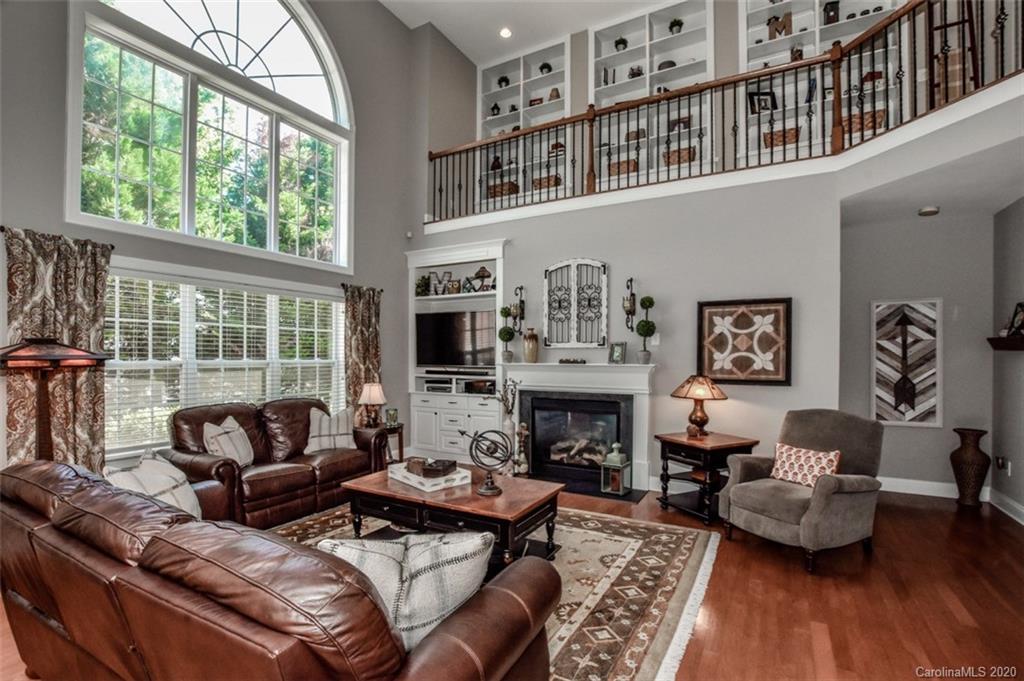 8723 Savannah Road Harrisburg, NC 28075 - Photo 10 of 44 a living room with furniture large window and a fireplace