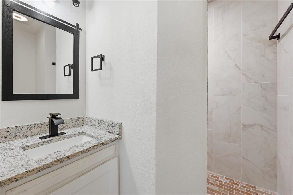 2804 Bent Tree Lane Arlington, TX 76016 - Photo 25 of 32 a bathroom with a granite countertop sink and a mirror