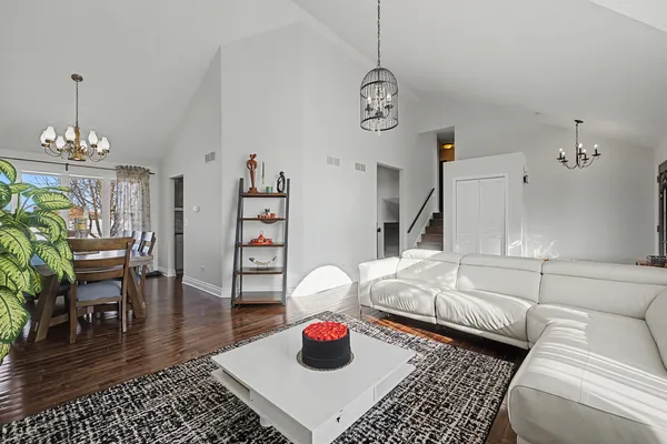 a living room with furniture and a chandelier