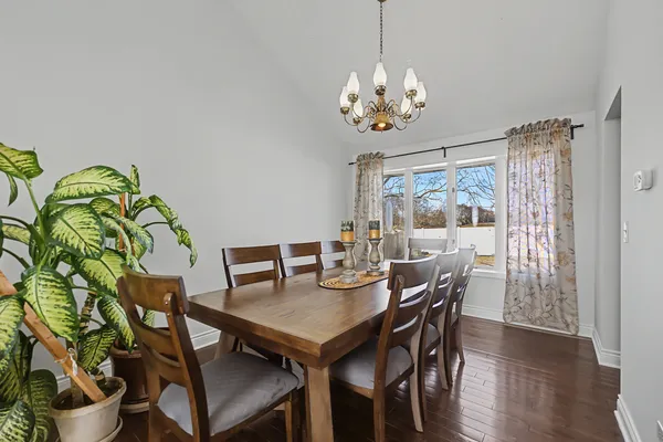 a view of a dining room with furniture wooden floor and chandelier