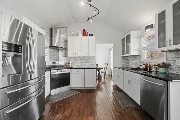 a kitchen with a refrigerator stove and sink