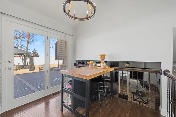 a room with a table chairs and wooden floor