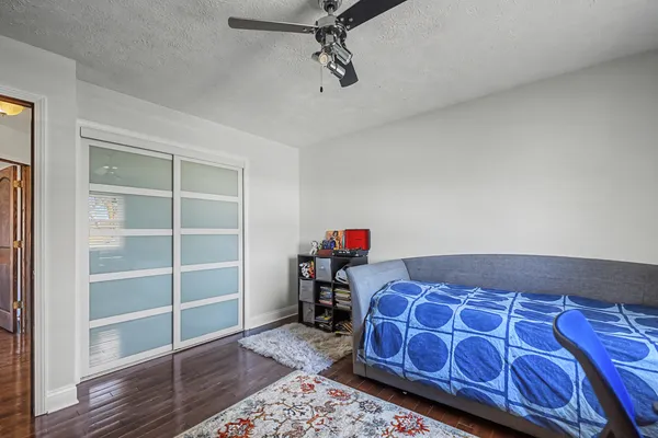 a bedroom with a bed and wooden floor