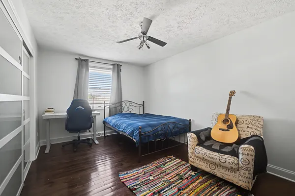 a bedroom with furniture and a wooden floor
