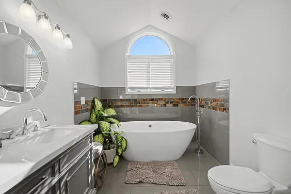 a spacious bathroom with a bathtub sink and toilet
