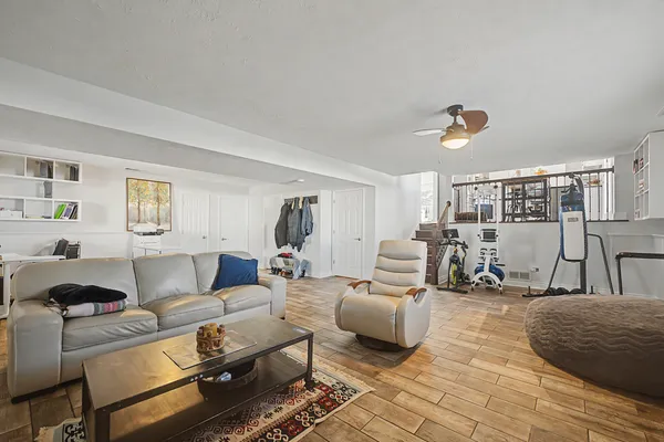 a living room with furniture and wooden floor