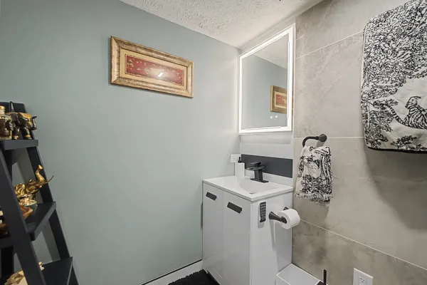 a bathroom with a sink toilet and mirror