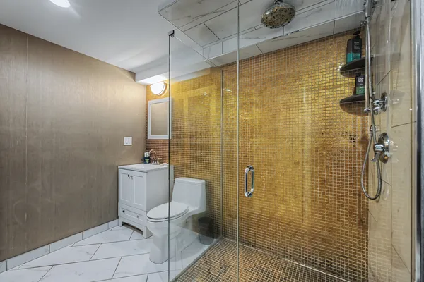 a bathroom with a toilet and a shower