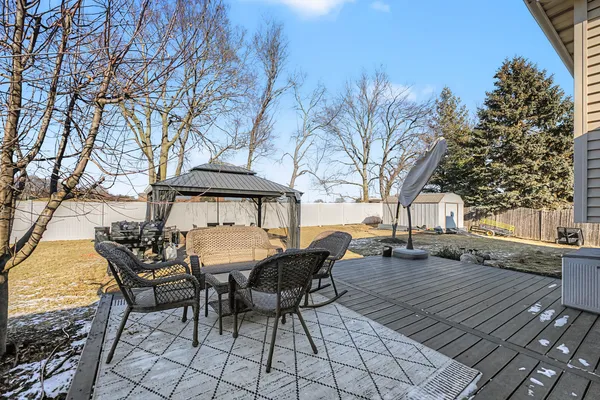 a view of a patio with table and chairs and couches