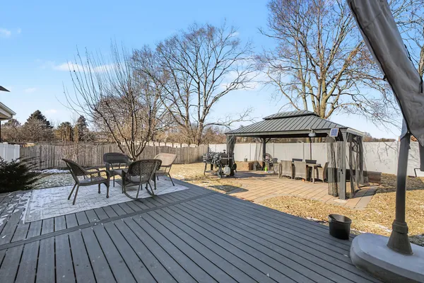 a view of a patio with table and chairs and wooden floor