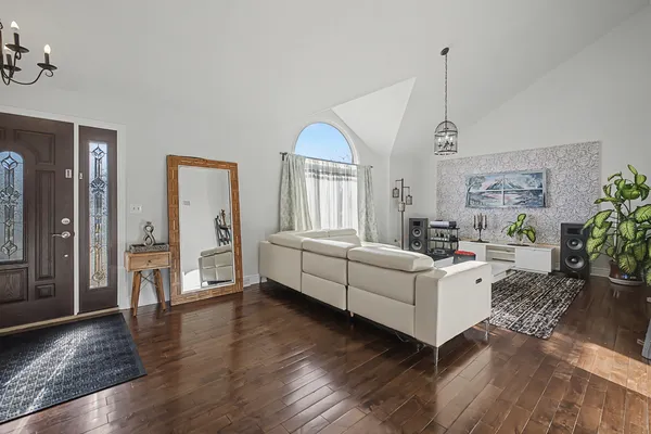 a living room with furniture and a wooden floor