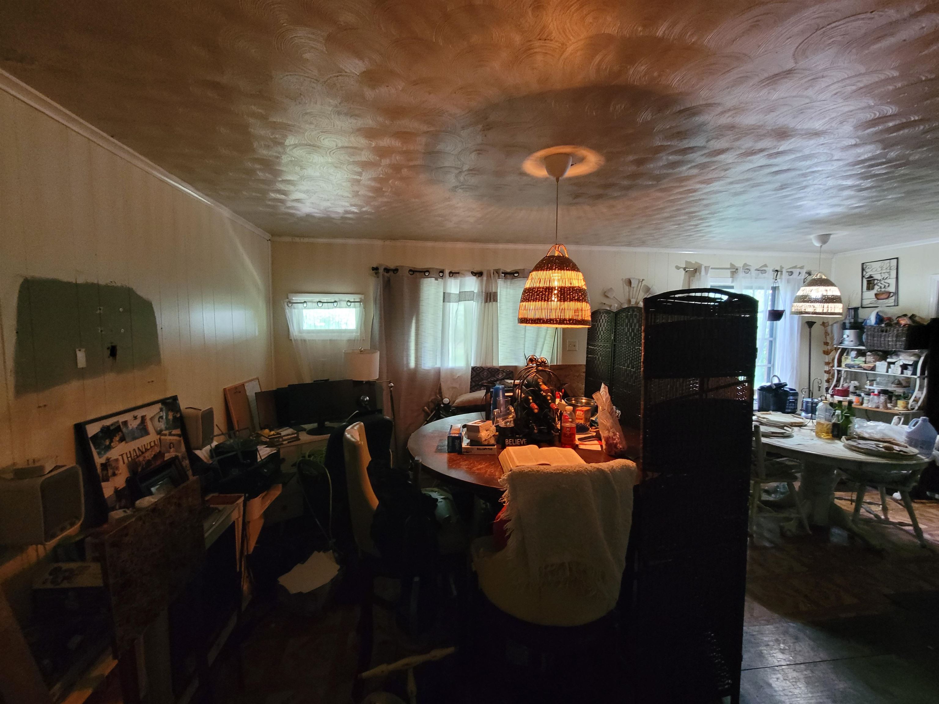 Dining space featuring a textured ceiling and crown molding