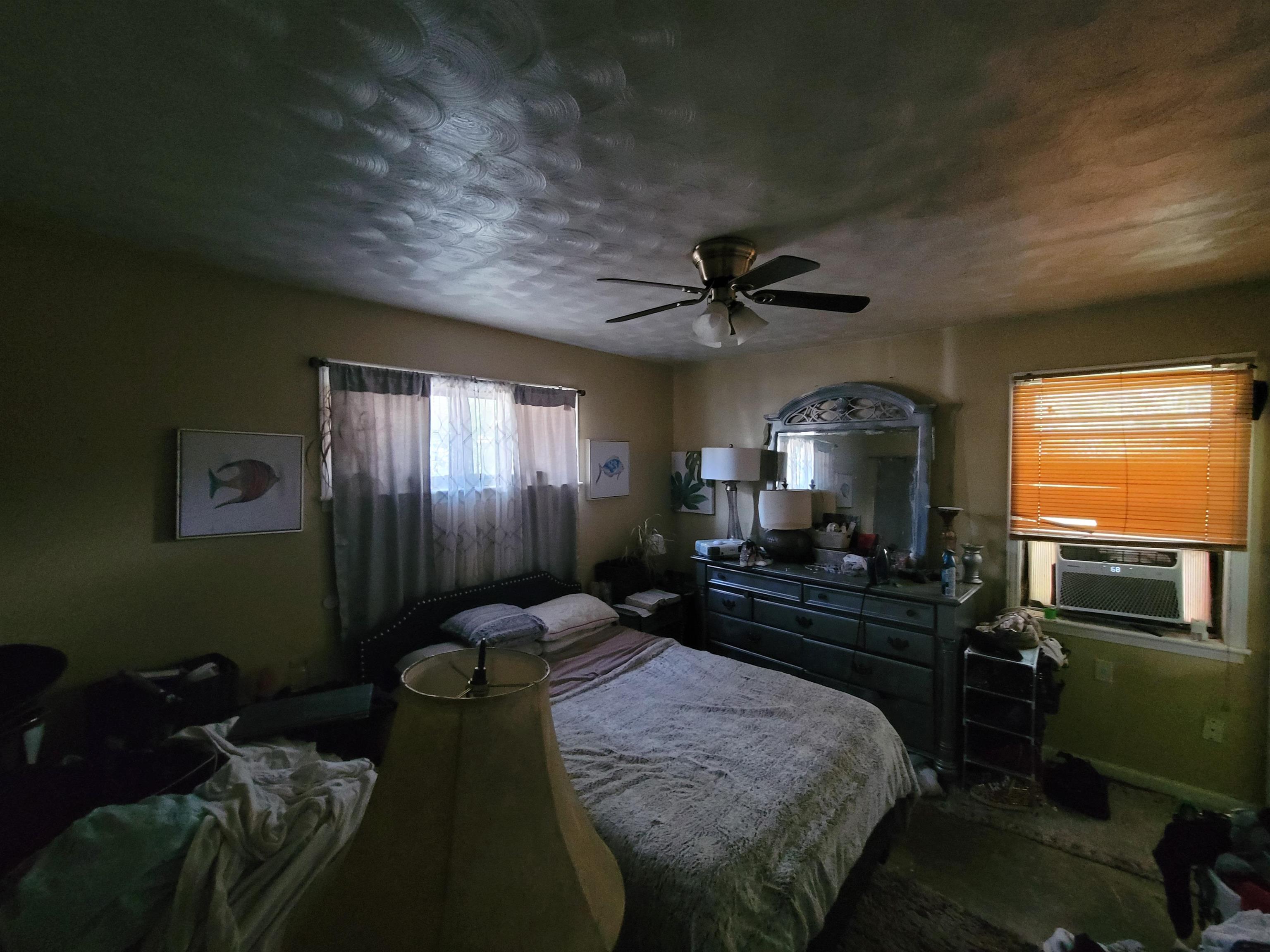 Bedroom featuring a textured ceiling and a ceiling fan