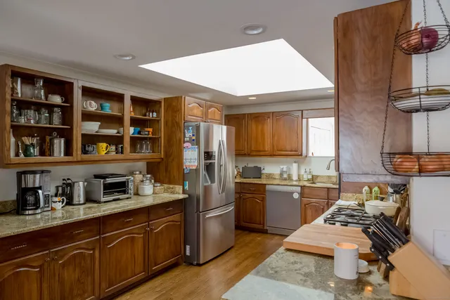 a kitchen with lots of counter top space and wooden floor