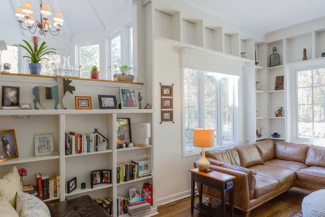 a living room with furniture cabinets and a window