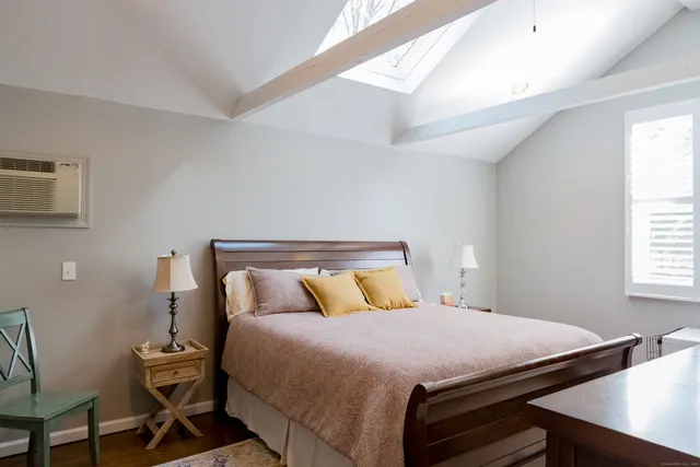 a bedroom with a bed and a desk