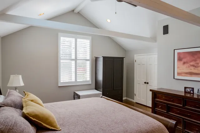 a bedroom with a bed and a window