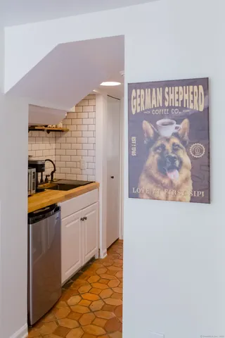 a kitchen with stainless steel appliances granite countertop a refrigerator and a stove