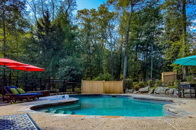 a view of a backyard with swimming pool