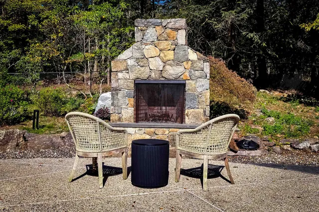 a view of a chairs and table in backyard