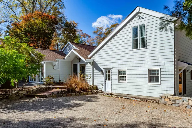 a view of a blue house with a yard
