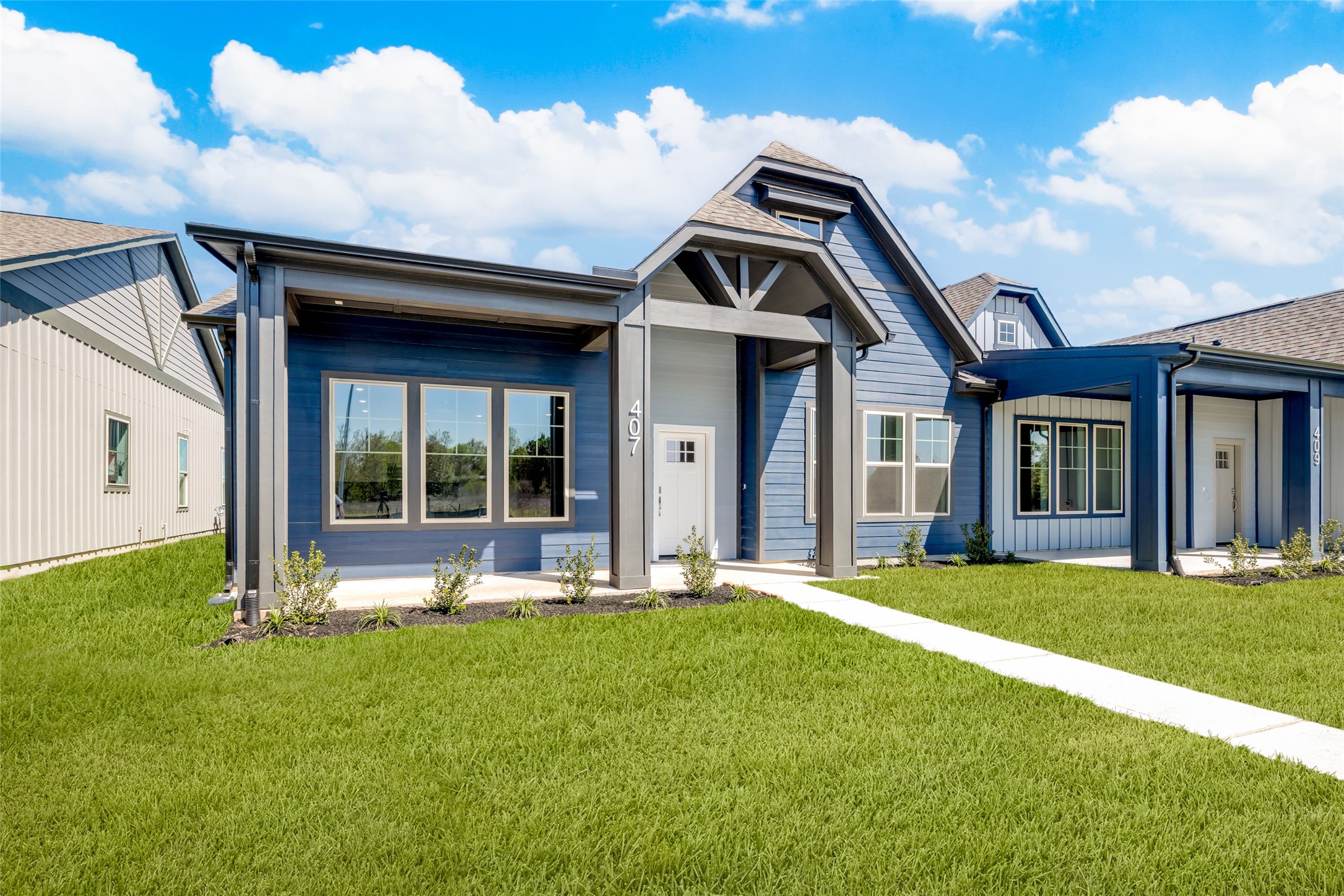 407 Legacy Point, Unit A Sealy, TX 77474 - Photo 2 of 28 a front view of a house with a yard