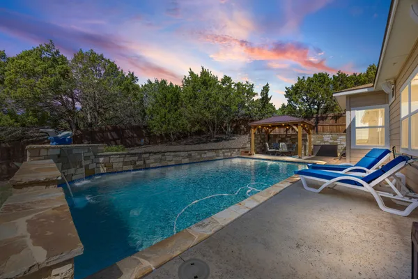 a view of a swimming pool with a lounge chair