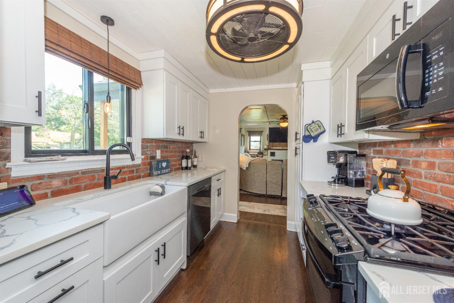 33 Orchard Road Middlesex, NJ 08846 - Photo 2 of 14 a kitchen with stainless steel appliances granite countertop a stove top oven a sink a counter space and living room view