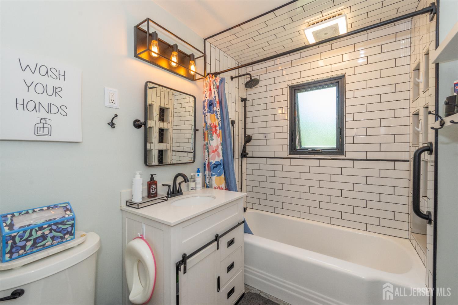 33 Orchard Road Middlesex, NJ 08846 - Photo 4 of 14 a bathroom with a sink a toilet and shower