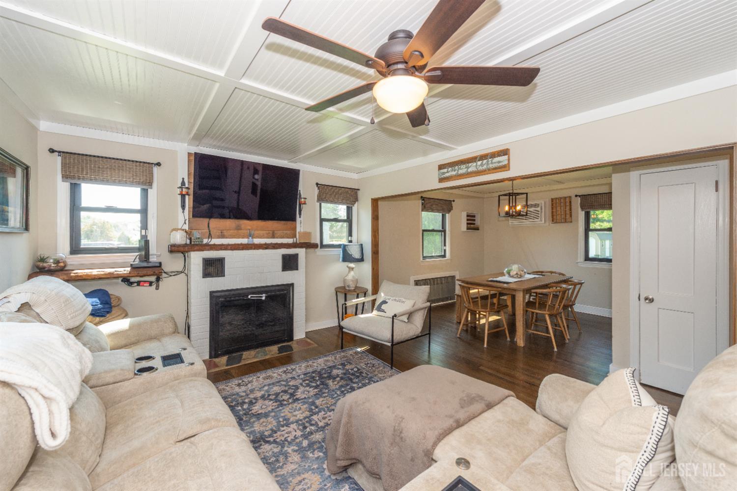 33 Orchard Road Middlesex, NJ 08846 - Photo 5 of 14 a living room with furniture a fireplace and a flat screen tv