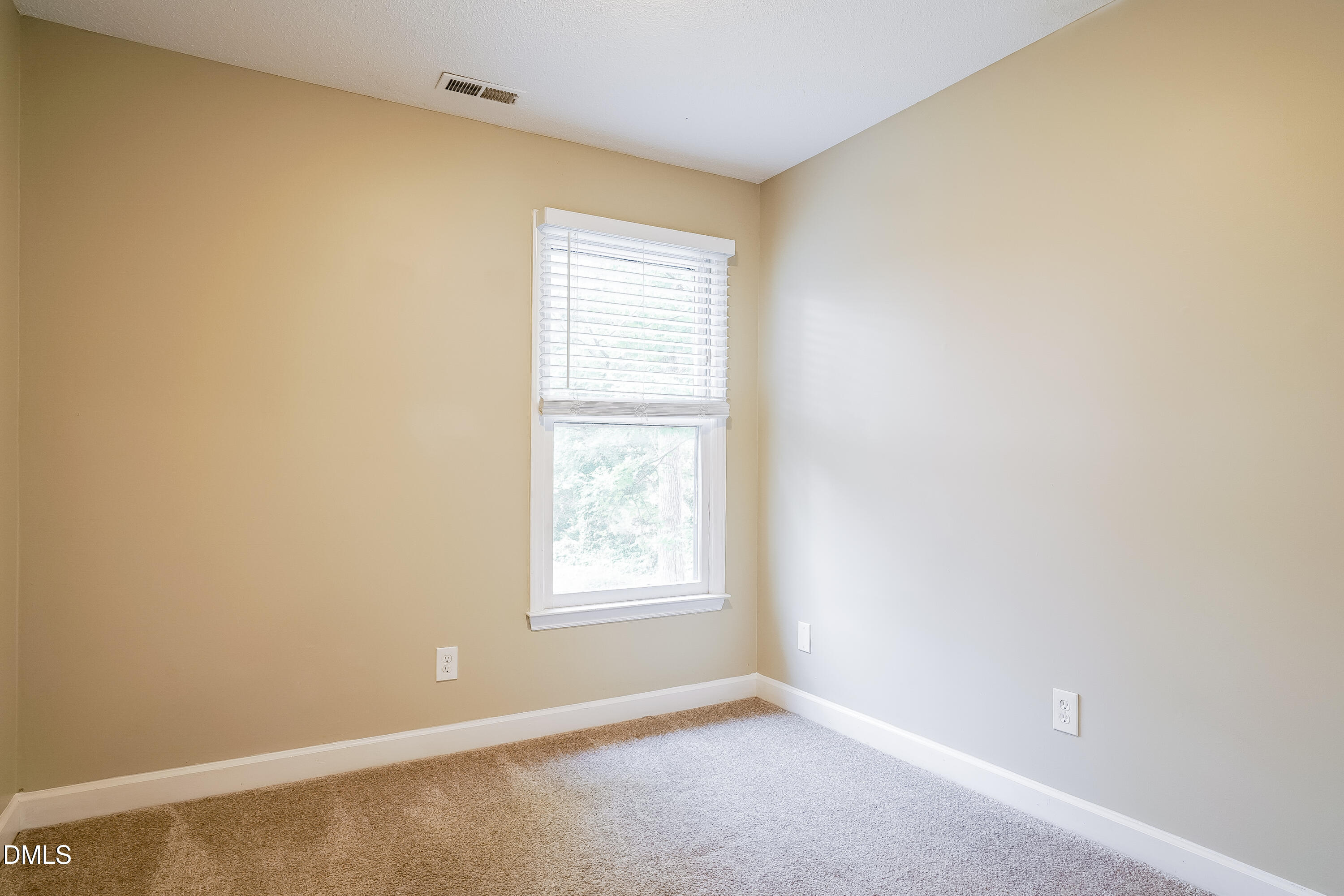 3636 Meadow Creek Lane Raleigh, NC 27616 - Photo 11 of 17 an empty room with windows