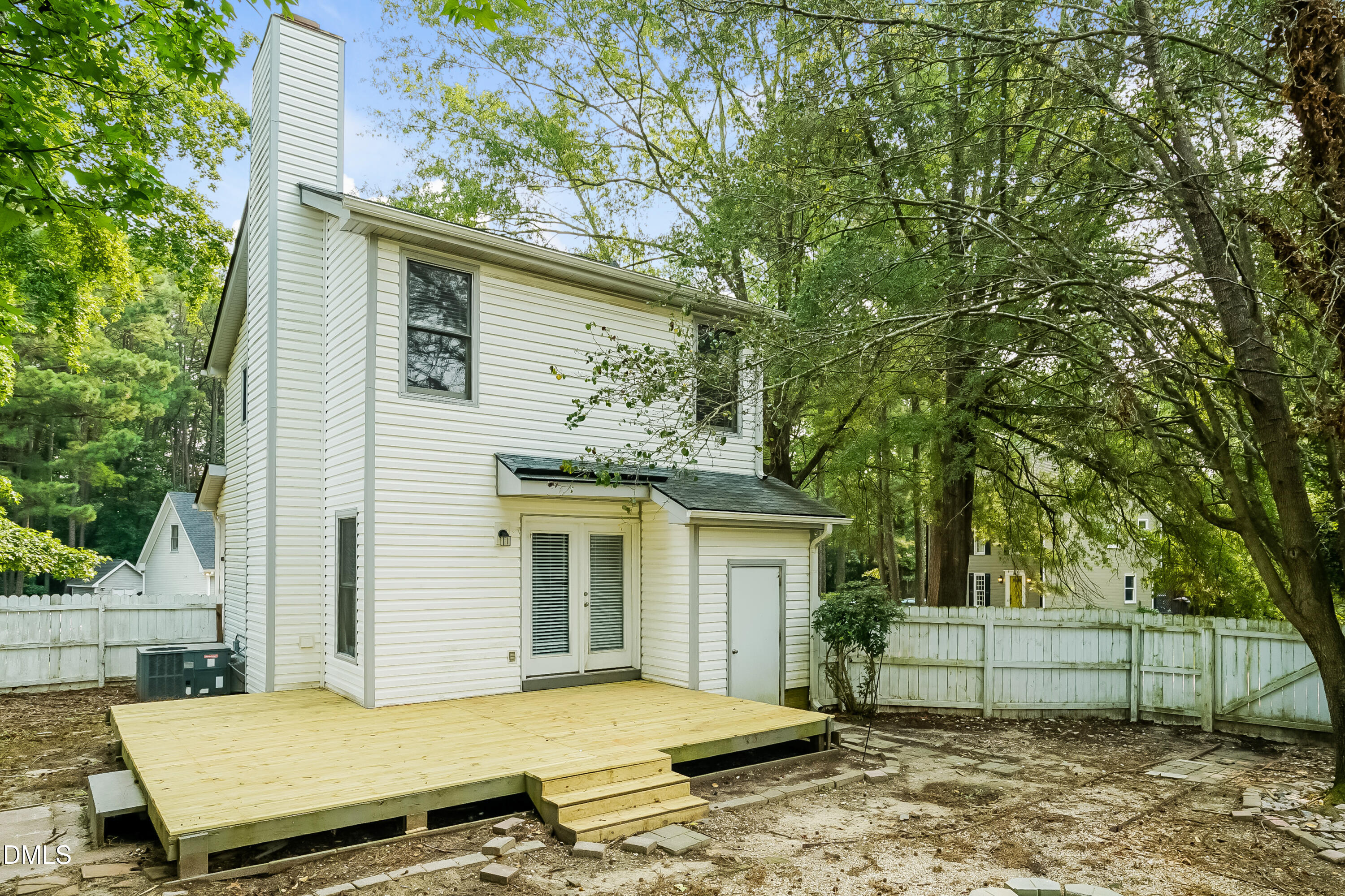 3636 Meadow Creek Lane Raleigh, NC 27616 - Photo 15 of 17 a view of a house with a large tree and wooden fence