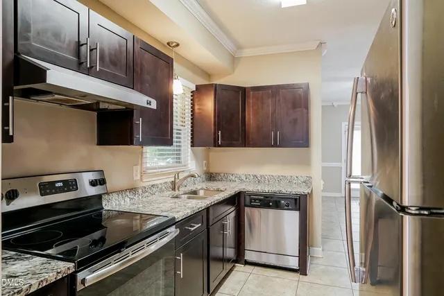 a kitchen with a sink stove and refrigerator